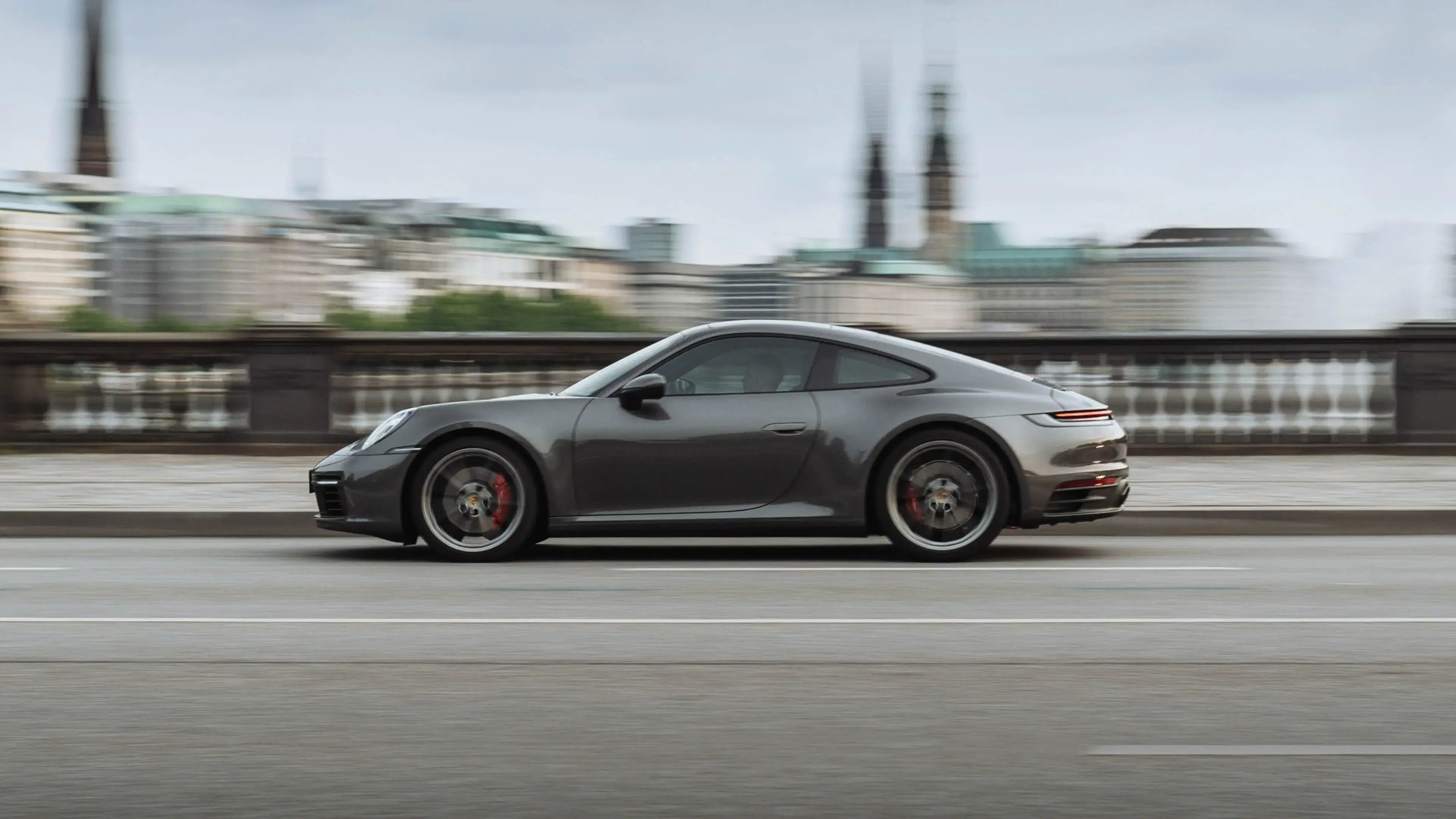 Porsche 911 from the side driving on the street